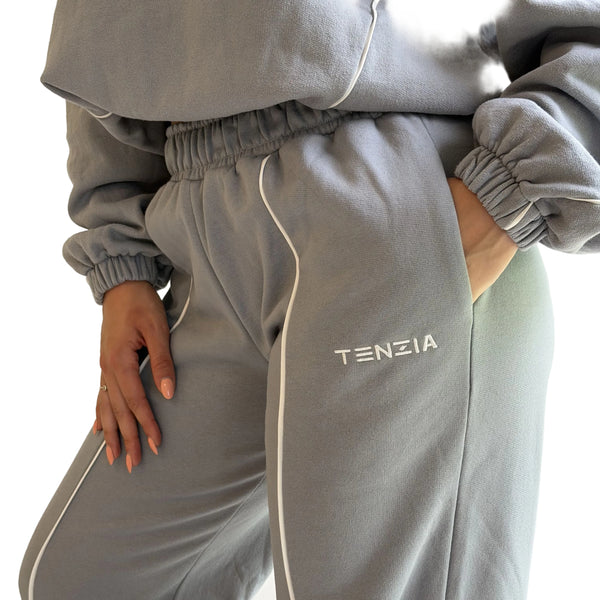 Gray tracksuit with 'TENZIA' branding on a plain background